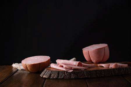 Mortadella. Traditional pork sausage with pistachios or black pepper. Italian delicacy from Bologna. High quality 4k footageの写真素材