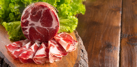 Capocollo or coppa is a traditional Italian and Corsican pork cut made from cured pork shoulder or neck. . Cut into very thin slices. Italian delicacy for aperitivo. Piacentina DOP.の写真素材