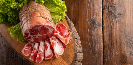 Capocollo or coppa is a traditional Italian and Corsican pork cut made from cured pork shoulder or neck. . Cut into very thin slices. Italian delicacy for aperitivo. Piacentina DOP.の写真素材