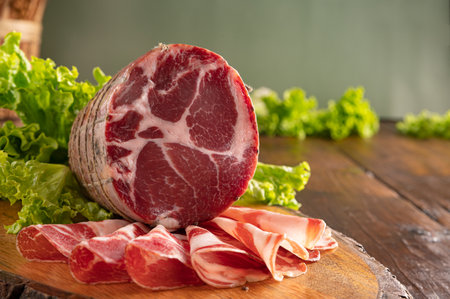 Capocollo or coppa is a traditional Italian and Corsican pork cut made from cured pork shoulder or neck. . Cut into very thin slices. Italian delicacy for aperitivo. Piacentina DOP.の写真素材