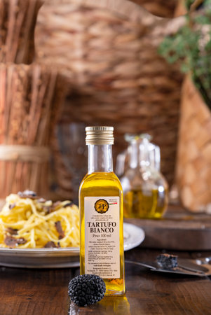 Truffle oil in bottles for cooking. Black truffle for Italian cuisine. Italian pasta with truffle. High quality photoの写真素材