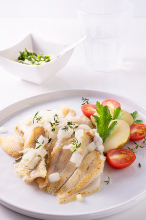 White fish on a plate. Beautifully served fish on a plate with vegetables and spices. High quality photoの写真素材
