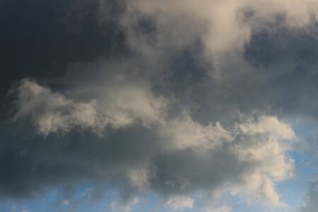 large gray fluffy clouds close up of the blue sky