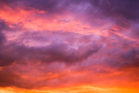 Storm red sky with gray clouds. Nature background. Dark storm clouds. Dramatic sky