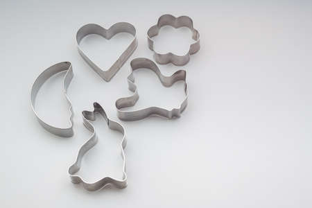 Various Christmas-themed cookie cutters. Xmas cookie cutters on white. Holiday pattern.