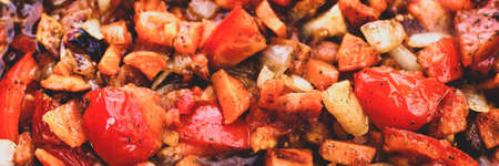 Frying vegetables. Roast onion, red pepper, carrot and tomatoes close up. Top view. Food background,...