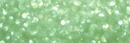 An abstract Green background with sparkle lights and bokeh. Useful as Christmas background or greeting card. Green blurred light. Banner.の写真素材
