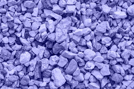 Very Peri. Color of the year 2022. Violet, purple colors. Close-up of crushed gravel as background...