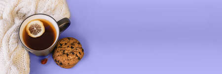 Very Peri. Color of the year 2022. Violet, purple colors. Autumn tea. Sweater, maple leaves, cookies and cup of tea with lemon. Cozy fall seasonの写真素材