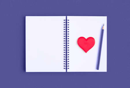Notebook with pencil, red heart. Open notebook on violet, purple color background, spiral notepad....