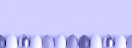 Easter banner with colorful Easter Egg in a row. Border over a violet background. Above view with copy space. Easter decorated eggs frame. Happy Easter card. Top view, flatlayの写真素材