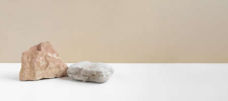 Stone Podium for promotion on beige Background. Natural rock pedestal. Two stone podiums . Beauty product mockup. Scene to show products. Showcase, display case. Front View, soft shadowの写真素材
