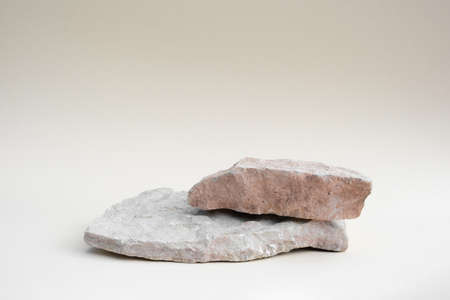 Stone Podium for promotion on beige Background. natural pedestal. Two stone podiums. beauty product mockup. scene to show products. Show case, display case. Front view, soft shadow.の写真素材