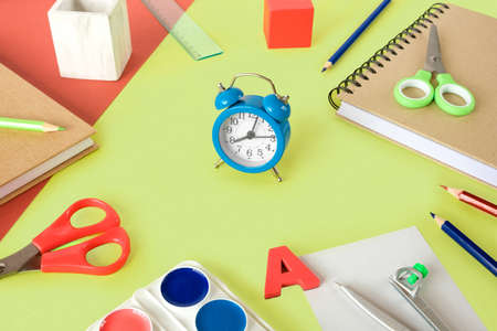 Colorful school supplies on light green background. Many Office Stationery Items flat lay. Back to...