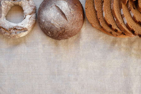 baked bread. Loaf of Bread. Fresh Bakery Products on Wooden Board. Healthy Food Concept. top view....