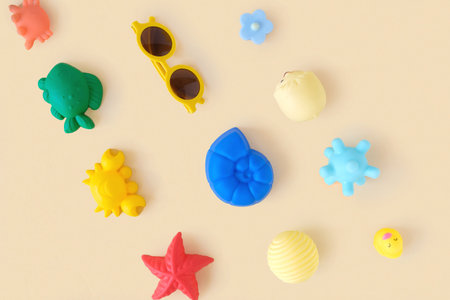 Set of beach accessories for children on beige background. Sand Kid's Toys. Mockup, free space for text. travel concept. Molds for the sandbox, sunglasses. Top View, Flat Lay. copyspace.の写真素材