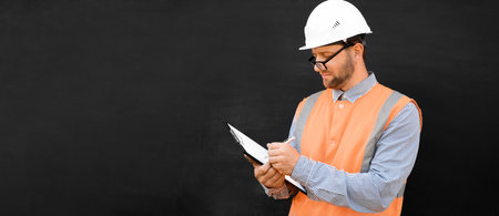 Male Engineer in a White Hard Hats and Orange West. Handsome Confident Build Worker Isolated on...