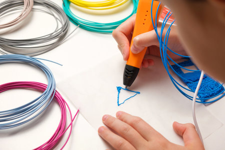Teen Girl Using 3d Pen. Printing with Colored Plastic Wire Filament. Child making a House, drawing...