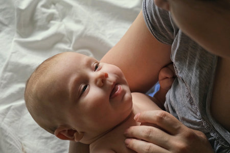 Close Up of Newborn Baby Dreaming on Mothers Chest. Authentic close up shot of Small Baby in...