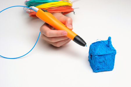 Teen Girl Using 3d Pen. Printing with Colored Plastic Wire Filament. Child making a House, drawing...