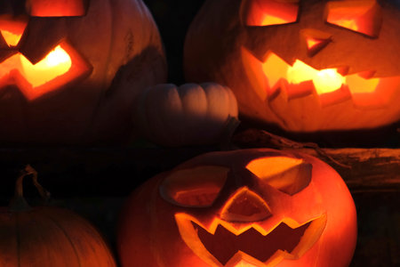 Halloween Pumpkin Head with Carved Scary Smiling Face at Night Outside. Jack-O-Lantern, Burning...