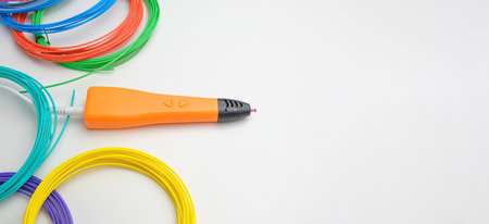3d pen. Printing with Colored Plastic Wire Filament. Child making a Christmas Three, Heart shape...