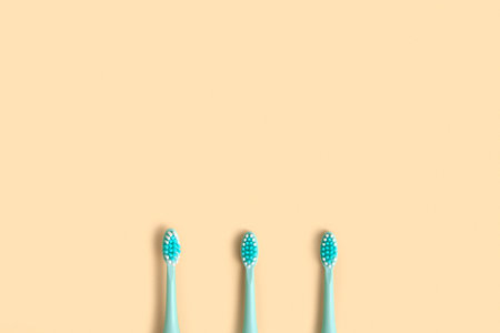 Toothbrushes on a beige neutral pastel color studio background. Top View Flat Lay, Copy Space. Dental Care Supplies. Oral Hygiene Gum Health, Healthy Teeth. Modern Dental Tooth Brush Set. clean teethの写真素材