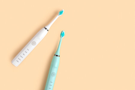 Electric Toothbrush. Top View, Flat Lay, Copy Space. Dental Care Supplies on Beige Pastel Studio...