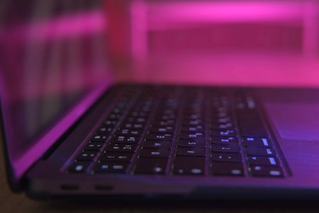 Side view of laptop computer at night. Close Up keyboard, buttons.の写真素材