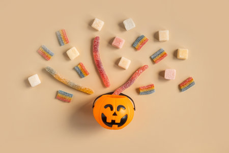 Halloween Jelly Beans Top View. Happy Halloween Party Border Beige Background. Aesthetic Accessories...