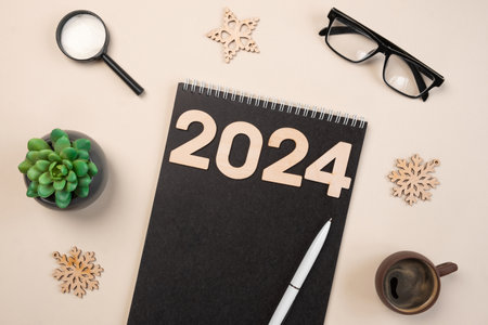 New Year Aims 2024. To Do List. Empty Notebook at the Desk with Holiday Decoration. Top view. Creating Plan, Resolution. New Life, Start Up, Beginning Concept. Business ideas. Goals, action, checklistの写真素材