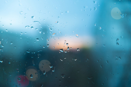 Drops of water during the rain Glass covered with rain. Blurred texture.