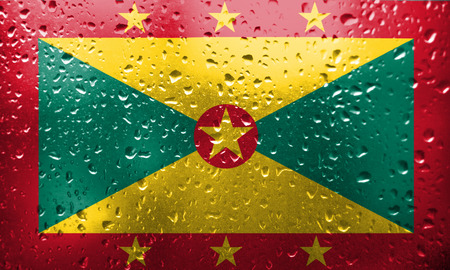 Texture of Grenada flag on the glass with drops of rain.の写真素材