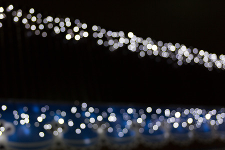 Two lines of light bulbs. Many blue lights blurred bokeh background in the night.