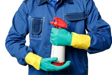 Men's hands in rubber gloves and a janitor's uniform hold chemical spray bottle for cleaning....