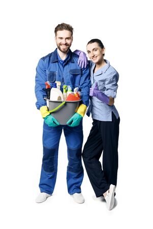 A young bearded smiling man in the uniform of a janitor holds a basket with moisturizing products, and maid-shaped women lean on his shoulder. Isolated on a white backgroundの写真素材