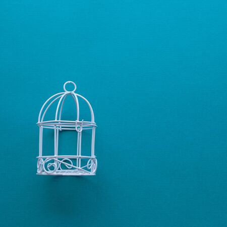 Small white decorative cage for interior decoration on a blueの写真素材