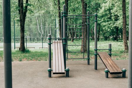 An empty training ground on the street, horizontal bars and benches for exercise on the press.の写真素材