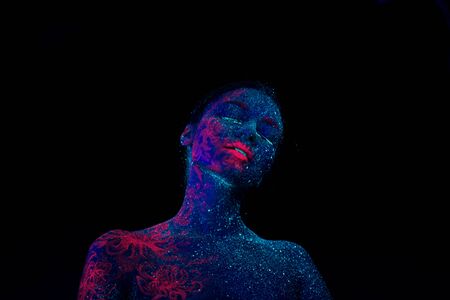 Picture of a pink jellyfish on the shoulder and face. Blue girl alien looks to the camera. Tilted her head to the shoulderの写真素材