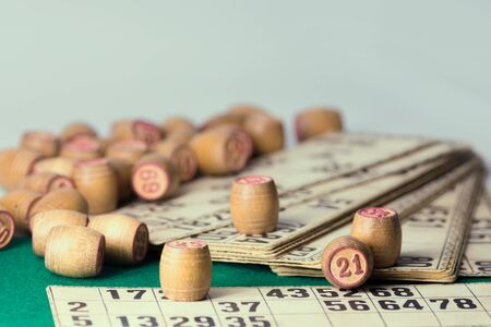 Old wooden lotto barrels and playing cards isolatedの写真素材