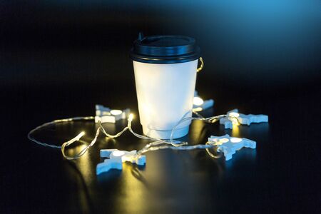 Takeaway paper cup on black background surroundedの写真素材