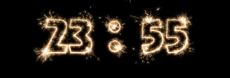 Isolated on black background inscription 23:55 made by sparklers in anticipation of the new year.