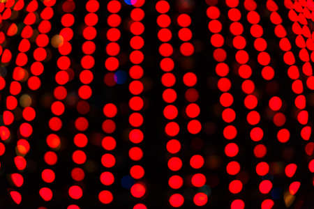 Abstract blurred bokeh texture from a variety of blue circles, burning light bulbs, christmas lightsの写真素材