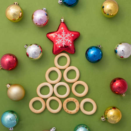 Christmas tree of bagels on a green background with a red star and a place to sign. Like Greeting...