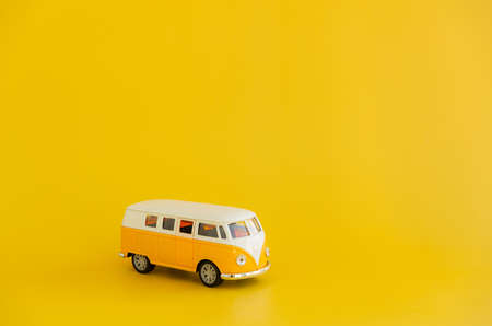 Toy minivan for hippies on a yellow backgroundの写真素材