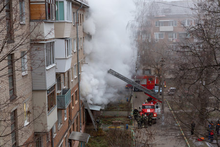 City Tula. Russia - December 01, 2020: Smoke during a fire in a multi-storey building. A fire truck...