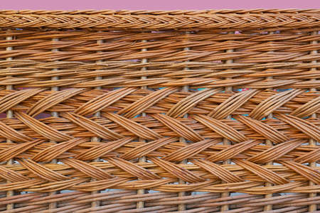 The texture of a pale brown wicker fence.の写真素材