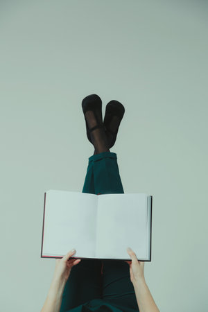 Female hands are holding an open book with white sheets and a place for a signature