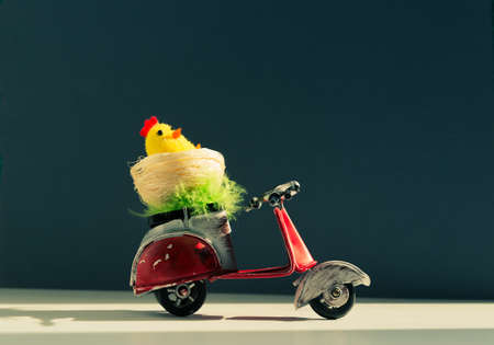 Chicken toys in a basket on a scooter.の写真素材