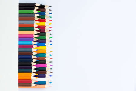 Set of colored watercolor pencils in a box isolated on a white background. View from aboveの写真素材